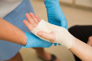 Nurse is treating patient after carpal tunnel syndrome operation